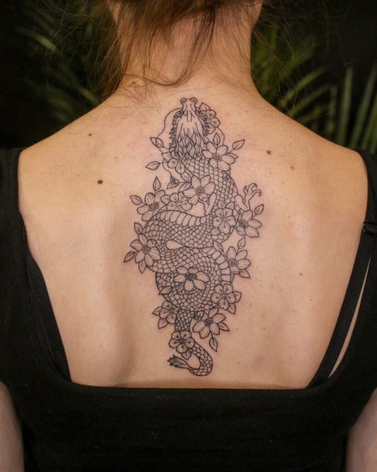 12. Ein Fallen-Tattoo eines Drachens mit Blumen