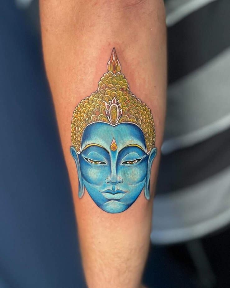 9. Eine blaue Buddha-Tätowierung 