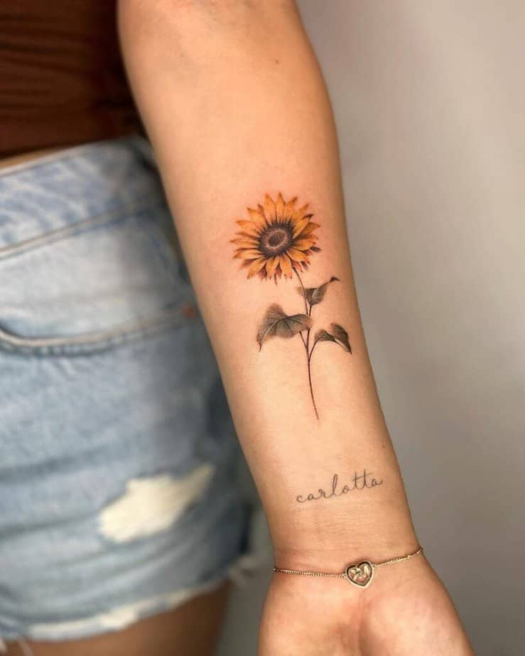 22. Ein Sonnenblumen-Tattoo mit einem Wort, einem Mantra oder einem Namen 