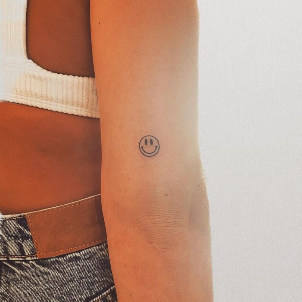 Ein Smiley-Tattoo auf der Rückseite des Arms