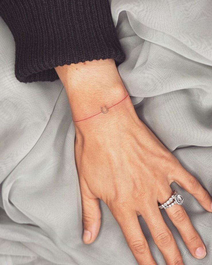 19. Ein Hufeisen-Tattoo am Handgelenk 