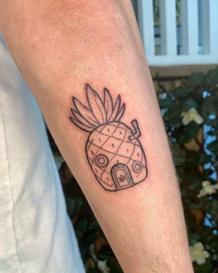13. Ein Tattoo mit dem Haus der Ananas auf der Rückseite des Arms