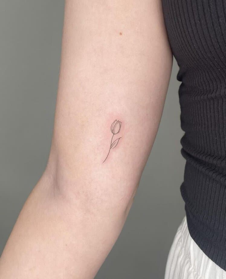 21. Ein minimalistisches Tulpen-Tattoo auf dem Bizeps
