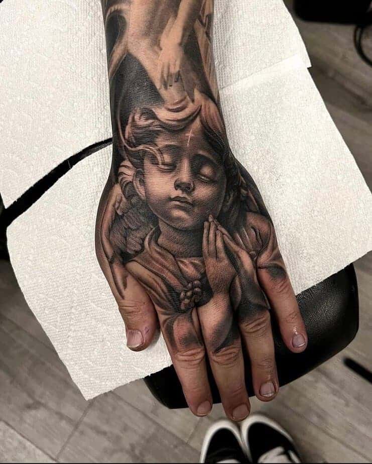 10. Hand Cherub Tattoo